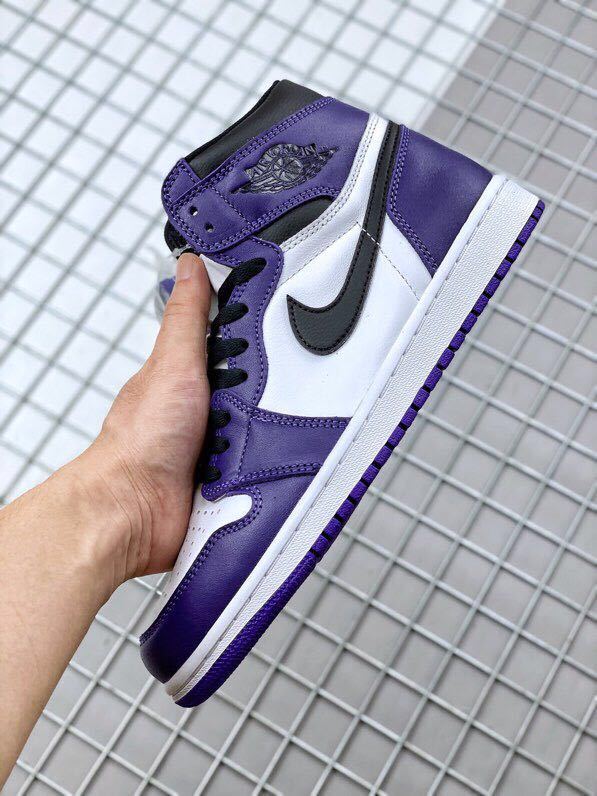 Side profile highlighting the purple overlays, white midfoot panel, black Swoosh, and white midsole.