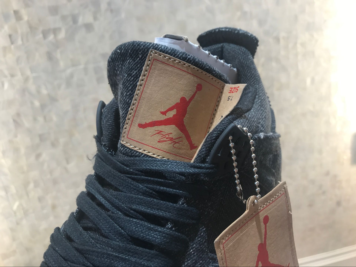 Close-up of the tan tongue label with red Jordan graphics and black laces.