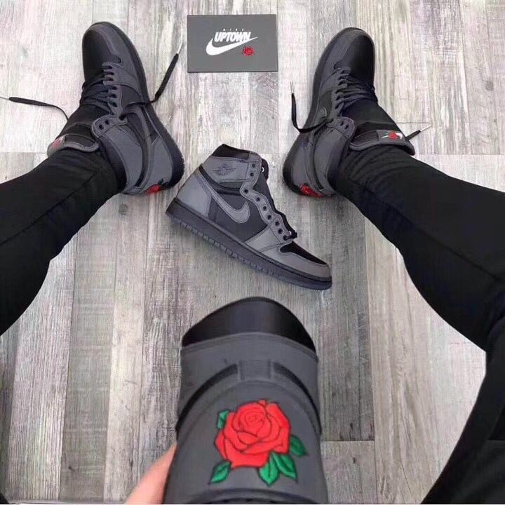 Lifestyle view of the sneakers being worn, with the rose heel embroidery visible.
