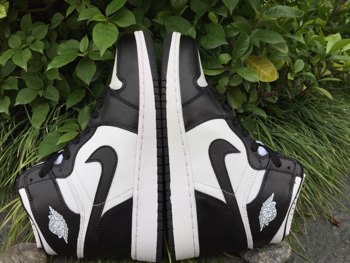 Rear-side view of the pair showing the black heel panels, white side sections, and outsole tread.