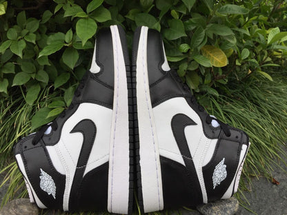 Rear-side view of the pair showing the black heel panels, white side sections, and outsole tread.