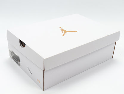 White Jordan shoe box with a gold Jumpman logo and a visible sample size marking.