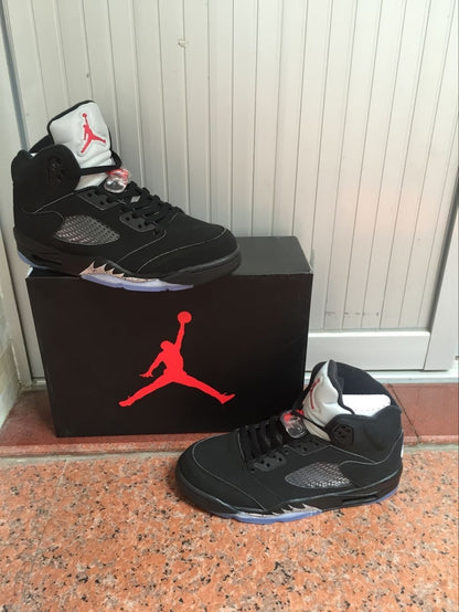 Pair of black high-top sneakers displayed with a Jordan-branded box.