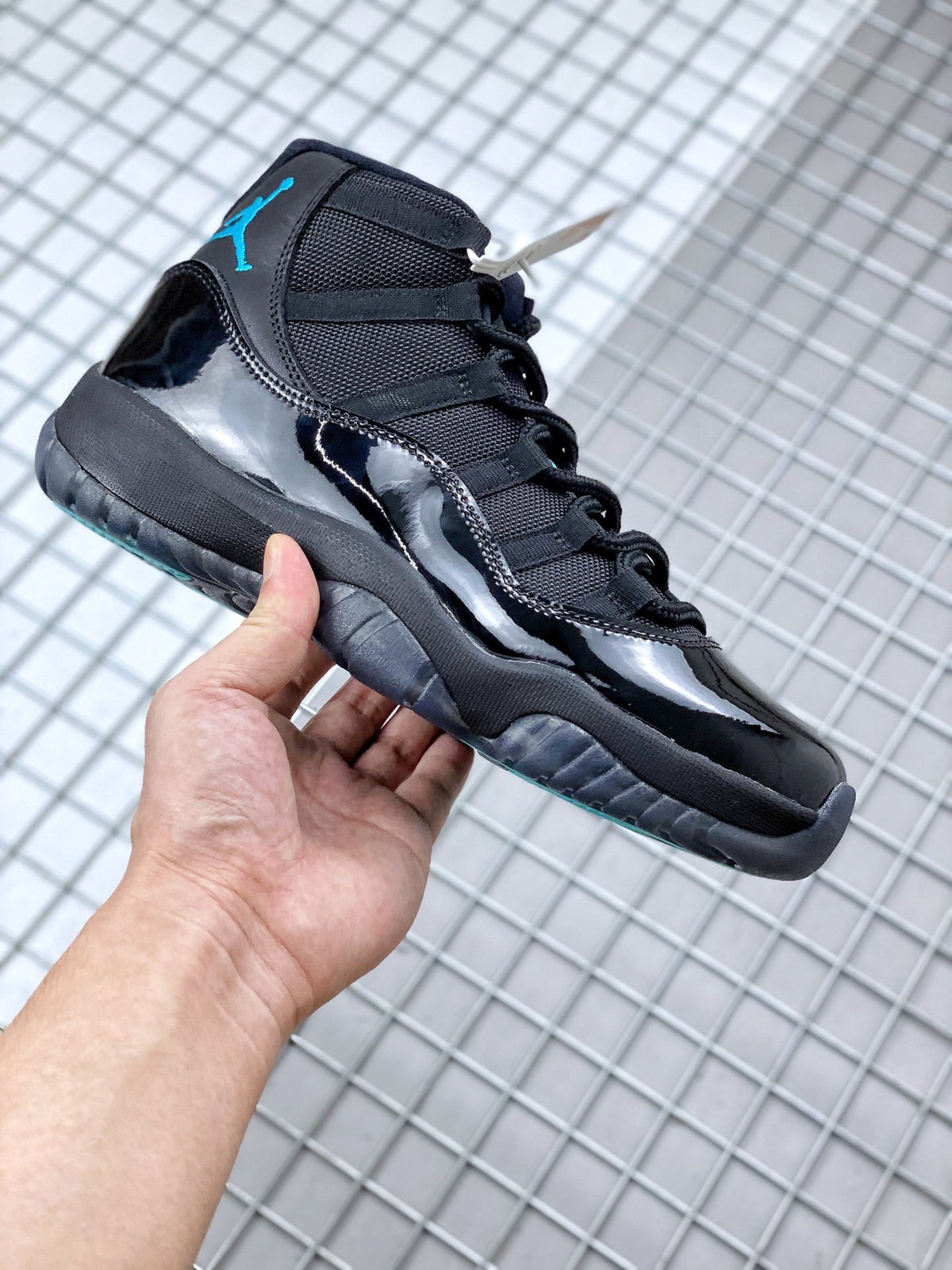 Side profile of the black sneaker highlighting the glossy side panel, black upper and dark sole.