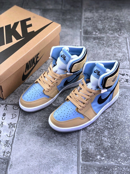 Pair of tan and light blue Jordan high-top sneakers displayed beside a branded shoebox.