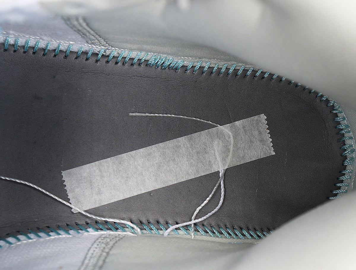 Close-up of the sneaker interior showing contrasting stitching around the insole and collar.