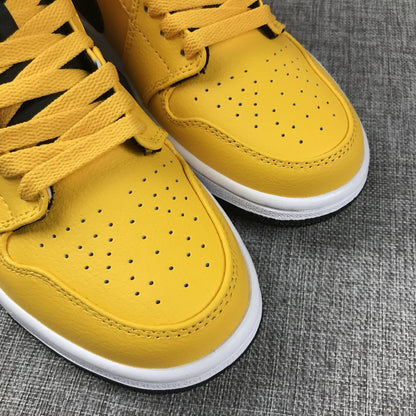 Close-up of the perforated yellow toe boxes and yellow laces.