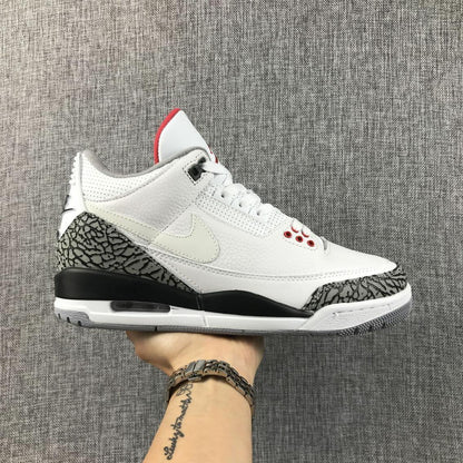Side profile of a white Jordan Air Jordan 3 sneaker with grey elephant-print panels, black midsole accents, and red details.