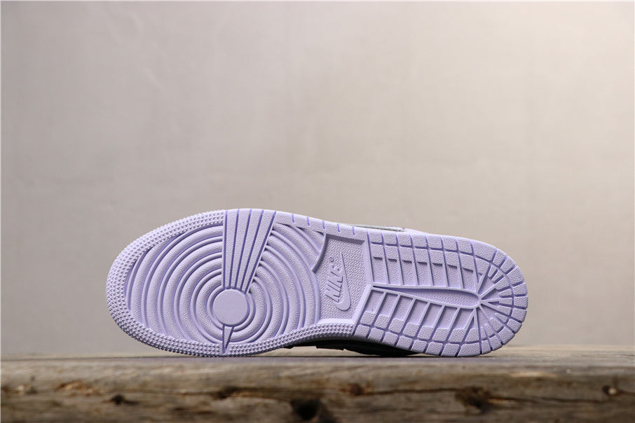 Underside view showing the light purple rubber outsole with circular pivot detail and segmented tread.