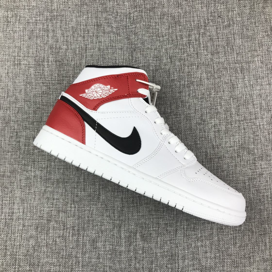 Single Jordan 1 Mid sneaker showing the white side panel, red overlays, and black side logo.