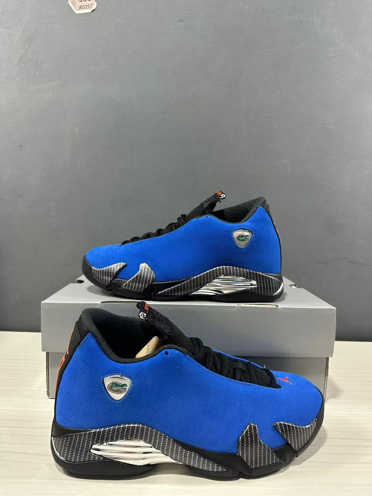 Pair of blue and black Jordan Air Jordan 14 Retro sneakers photographed from side and three-quarter angles.