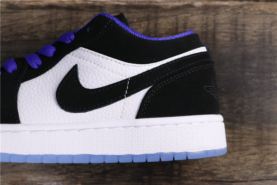 Side close-up showing the black Swoosh, white textured panels, and blue-tinted outsole