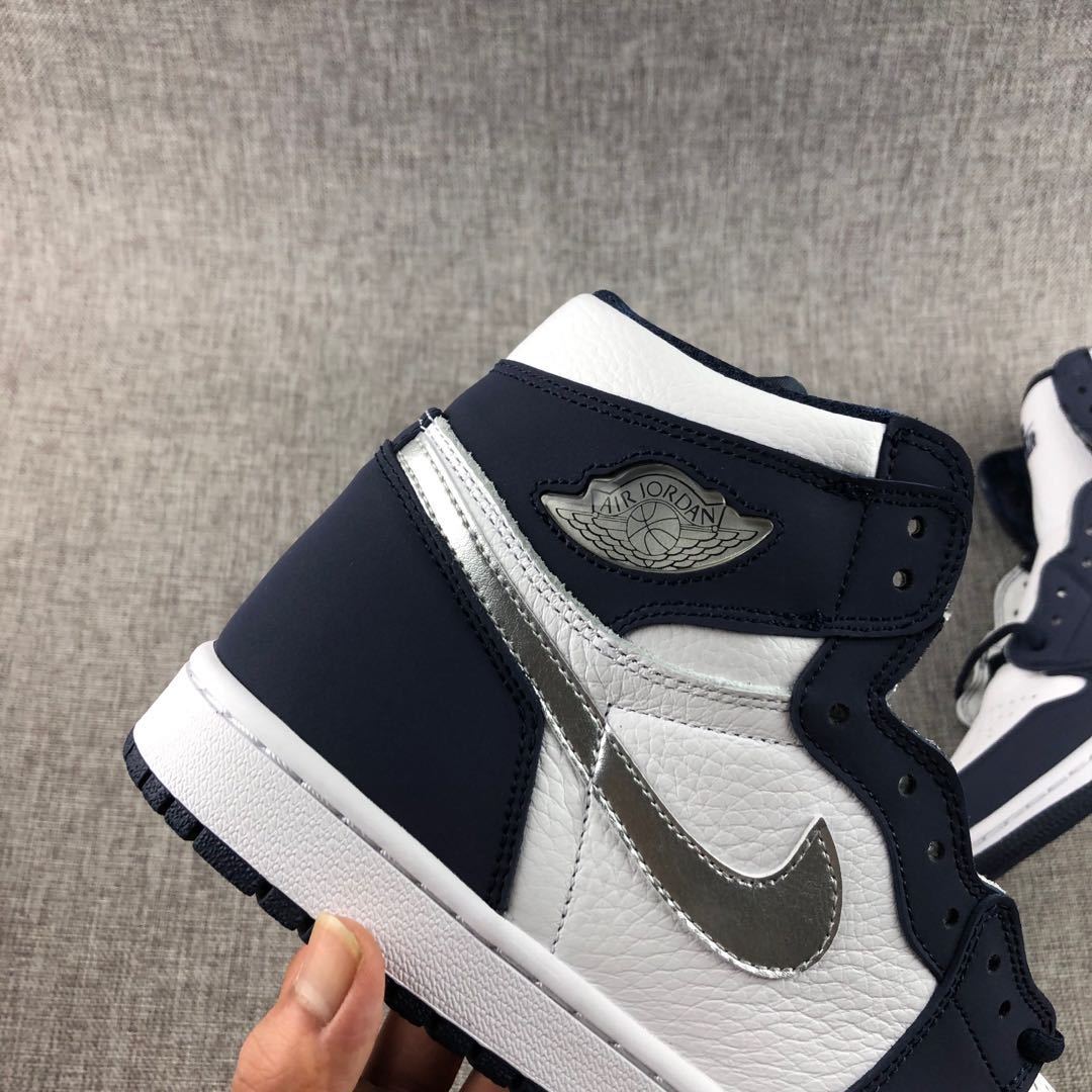 Close-up of the navy ankle collar, silver Swoosh and wing-style ankle emblem.