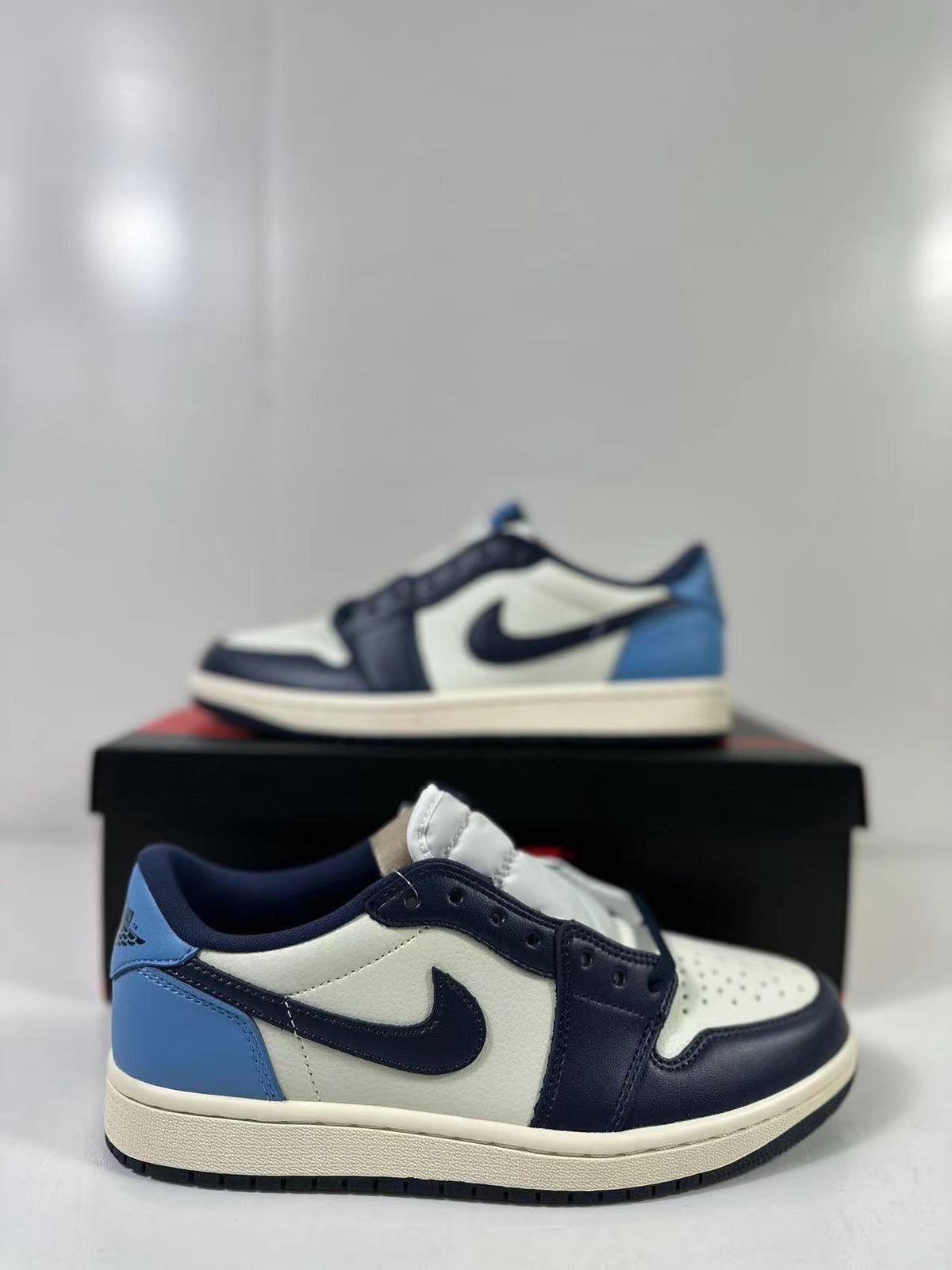 Close view of the low-top sneaker showing the side branding, blue heel, and layered upper.