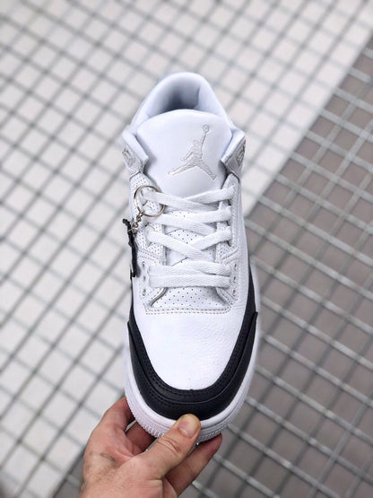 Top view showing the padded tongue, lace fastening, perforations, and black toe overlay.