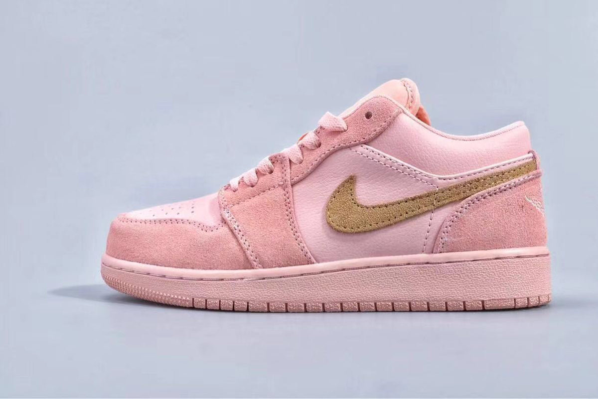 Full side profile of a pink low-top sneaker with a gold side logo and matching outsole.