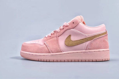 Full side profile of a pink low-top sneaker with a gold side logo and matching outsole.