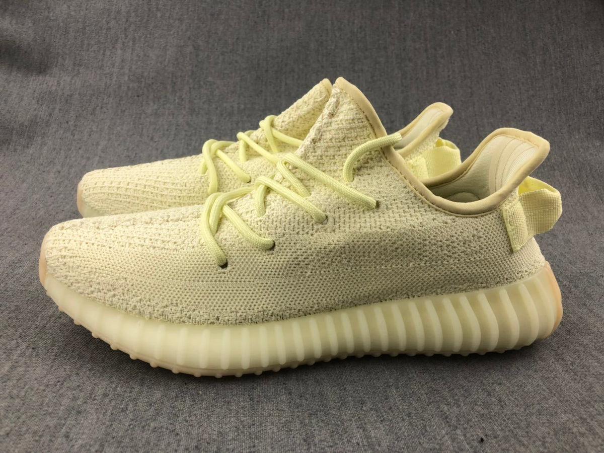 Pair of pale cream 350 V2 sneakers shown in an angled side view.