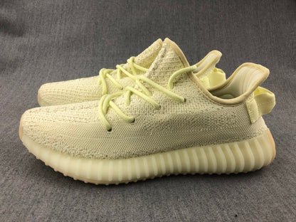 Pair of pale cream 350 V2 sneakers shown in an angled side view.