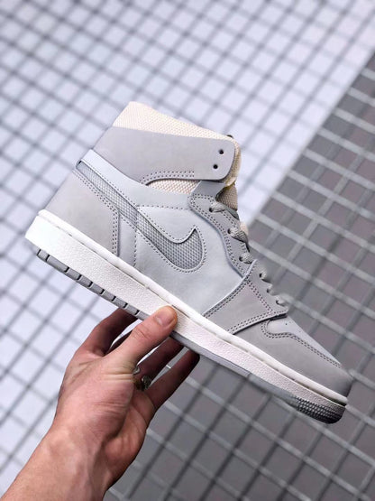 Side profile of the gray high-top sneaker showing the layered upper, Swoosh, white midsole, and gray outsole.