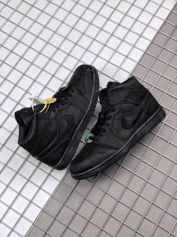 Pair of black high-top sneakers displayed from an overhead angle.