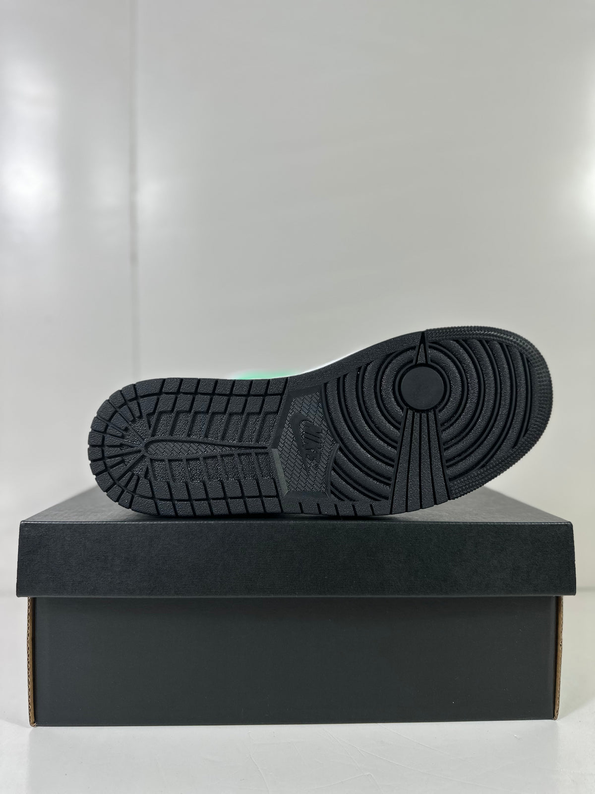Outsole view showing the black patterned rubber sole of the sneaker.
