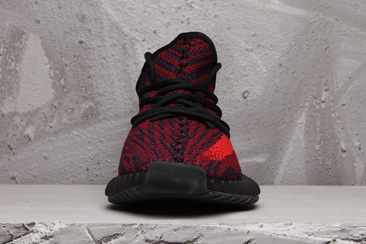 Front view showing the black laces, patterned knit upper, and rounded toe.