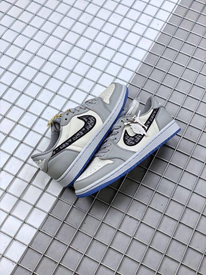Pair of grey and white low-top sneakers arranged on a metal grid surface.