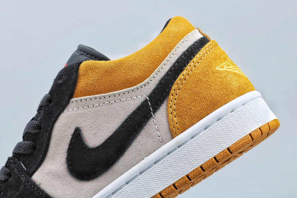 Close-up of the lateral side showing the black Swoosh, light side panel, and yellow heel.