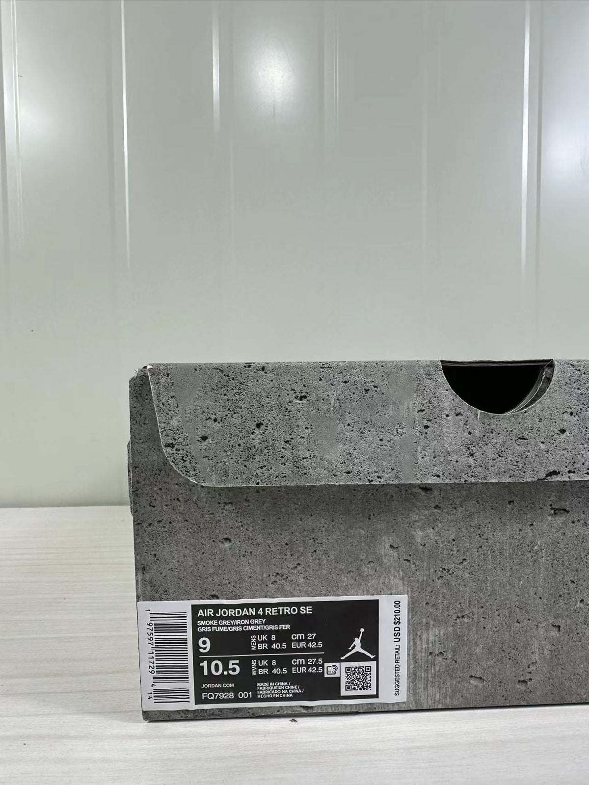 Close view of the product box label identifying Air Jordan 4 Retro SE, Smoke Grey, style code FQ7928-001, and a size 9 sample.