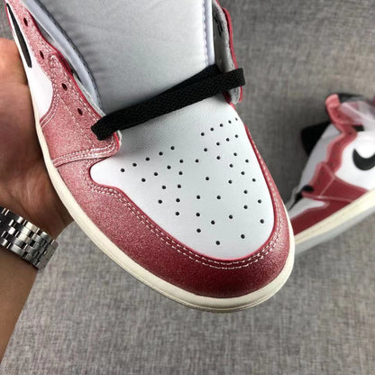 Close-up of the white perforated toe box, red overlays and black laces.