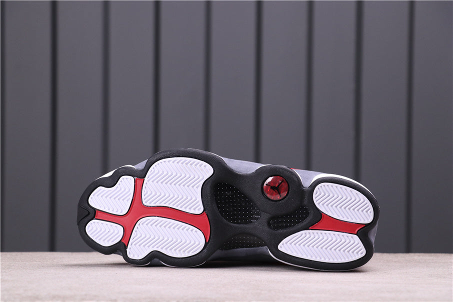 Underside showing the black and white outsole with red accents.