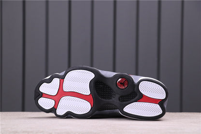 Underside showing the black and white outsole with red accents.