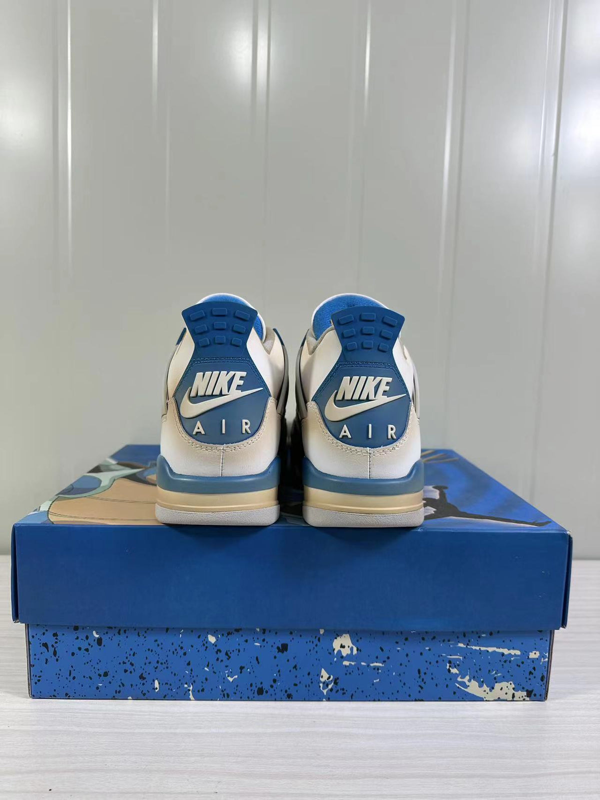 Rear view of the pair showing blue heel panels, Nike branding, and AIR lettering.