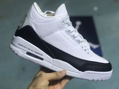 Angled view of the white and black sneaker with printed midsole text.