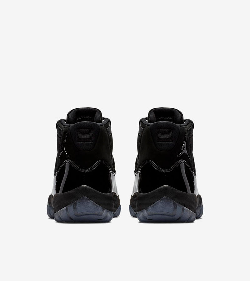 Studio rear view of a pair of black high-top sneakers.