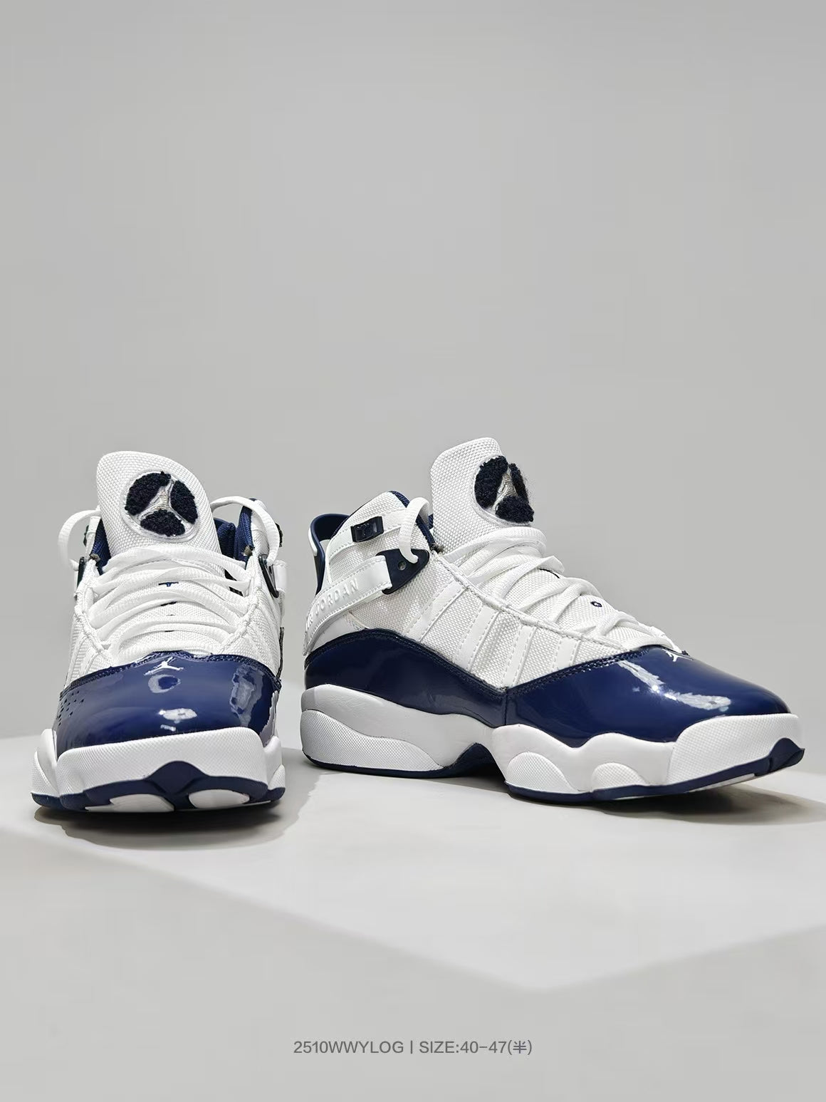 Front three-quarter view showing the white laces, navy toe overlays, and sculpted outsole.