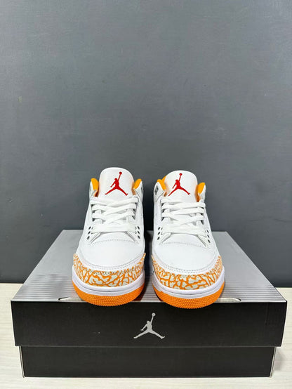 Front view of the pair showing white laces, red tongue branding, orange outsole edges and patterned toe panels.