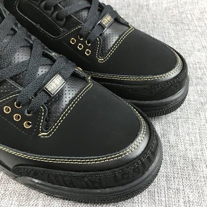 Three-quarter view of the pair showing black uppers and gold details