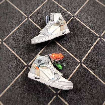 Two grey and white high-top sneakers displayed with orange and green spare laces.