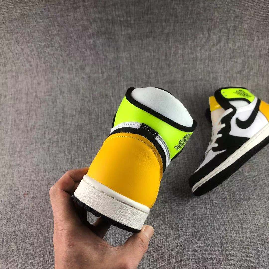 Rear view showing the yellow-gold heel panel, Volt collar and white midsole.