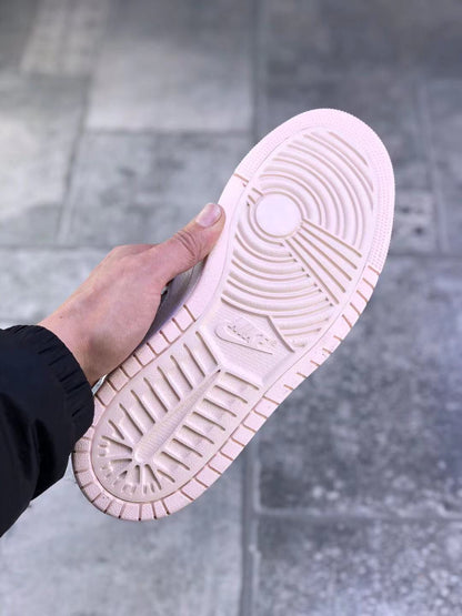 Bottom view of the sneaker showing the pale pink outsole and circular traction pattern.