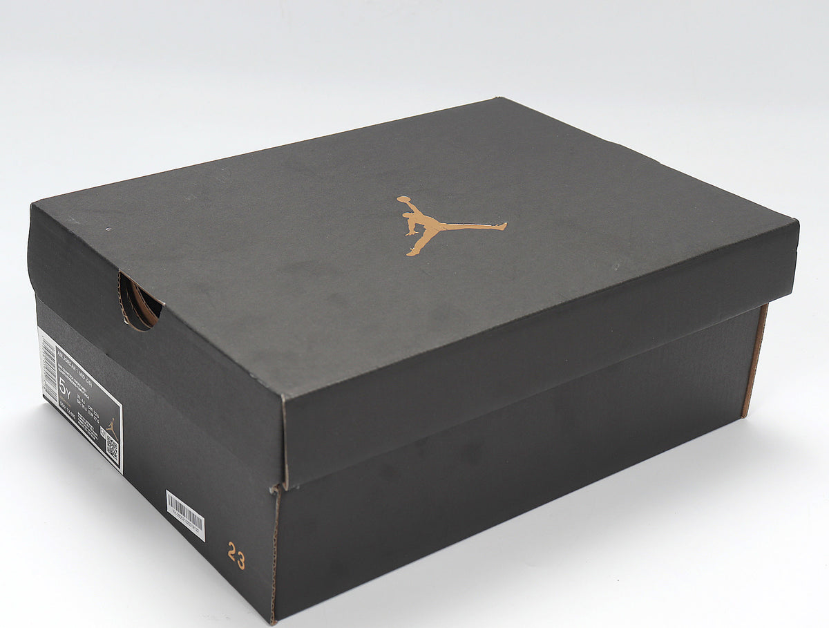 Black Jordan shoebox with a gold Jumpman logo and a visible size marking on the box side.