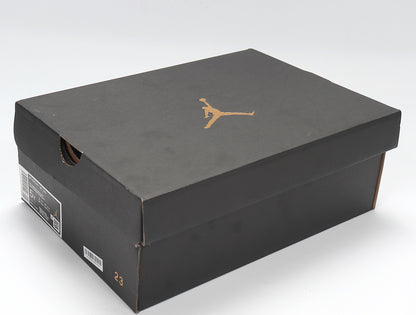 Black Jordan shoebox with a gold Jumpman logo and a visible size marking on the box side.