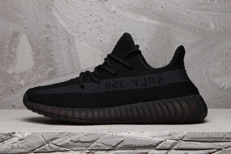 Side profile of a black Yeezy 350 V2 sneaker with a tonal SPLY-350 stripe.