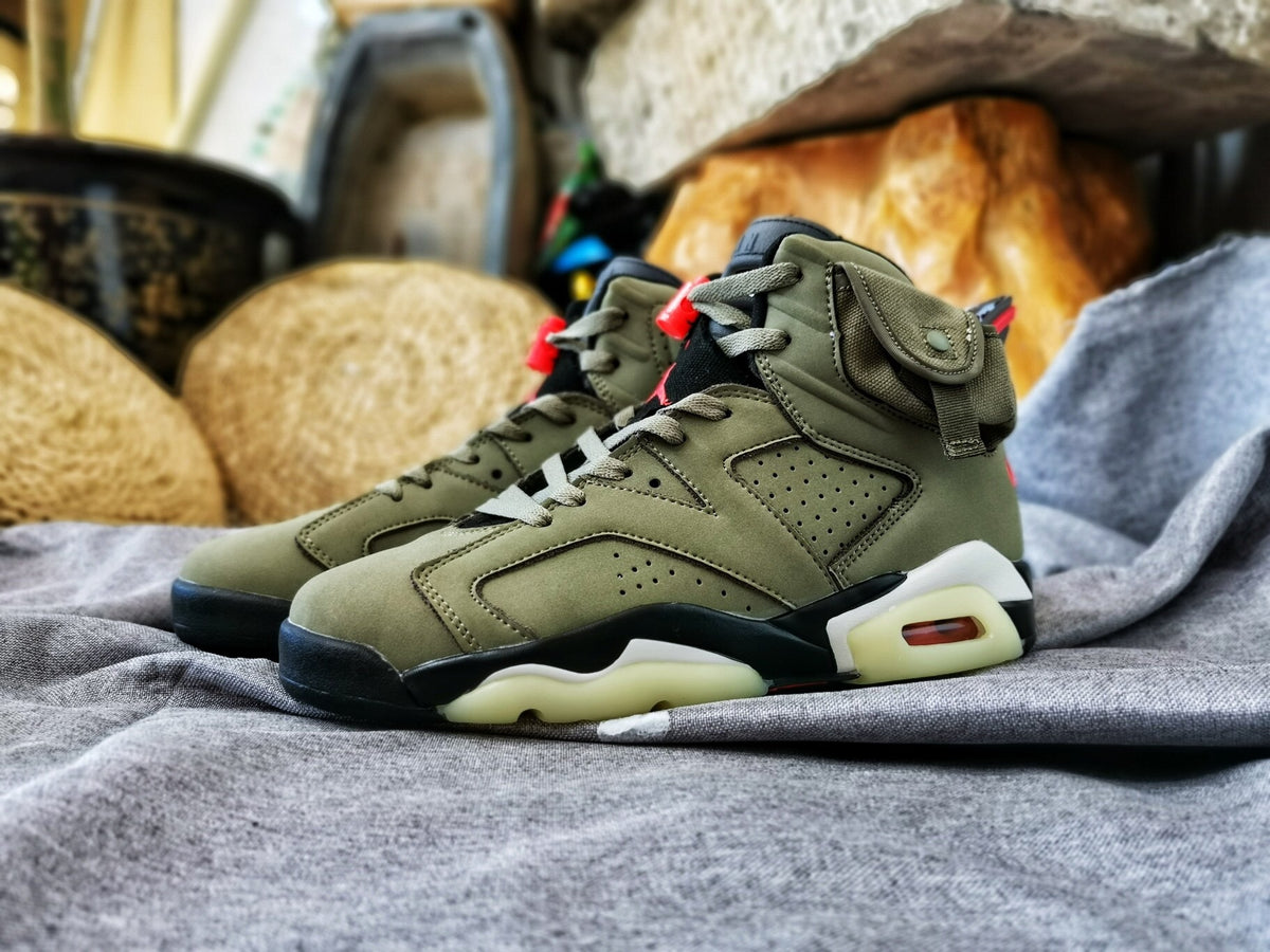 Side profile of the olive high-top sneaker showing its layered construction, black midsole sections, and translucent outsole.