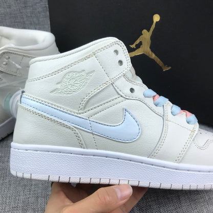 Close-up side view showing the embossed winged branding, pastel blue Swoosh and white midsole.