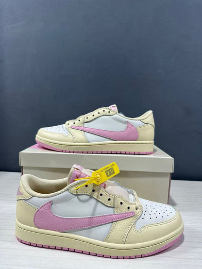Close angled view of the pair highlighting the perforated toe box, lace panels and pink side branding.