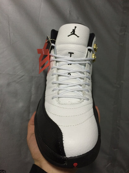 Top-down view of the white and black sneaker showing the lacing layout, tongue logo, and black mudguard.