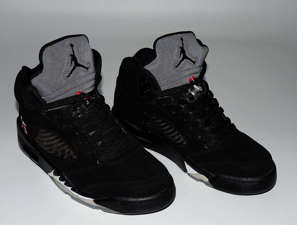 Pair of black Air Jordan 5 high-top sneakers viewed from the front, with gray tongues and red details